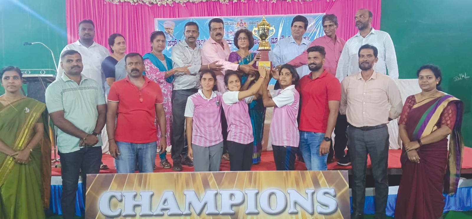 Students receiving a sports championship trophy